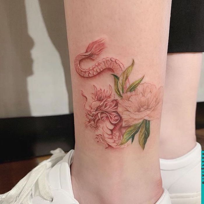 red dragon tattoo, with a peony flower next to it, ankle tattoo, woman wearing white sneakers