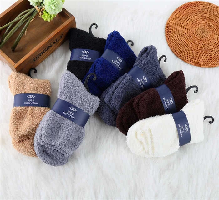 lots of pairs of cozy socks in different colors, what to get your boyfriend for christmas, wooden box with flowers inside