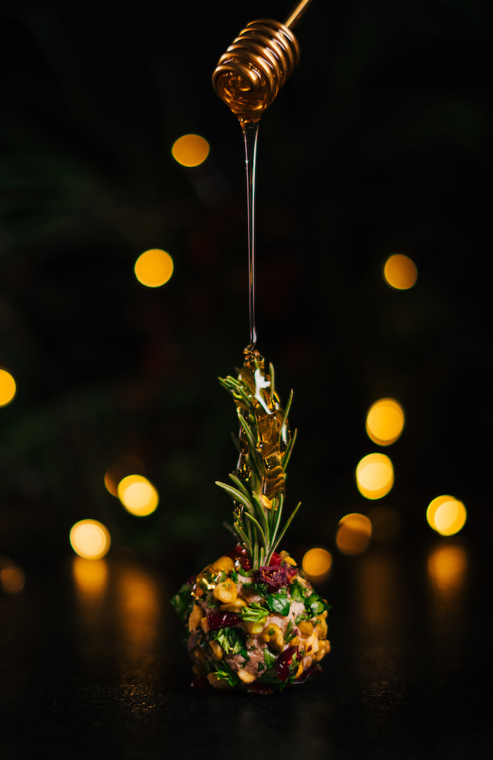 honey dripping over cream cheese ball, covered with different garnishes, cream cheese christmas appetizers