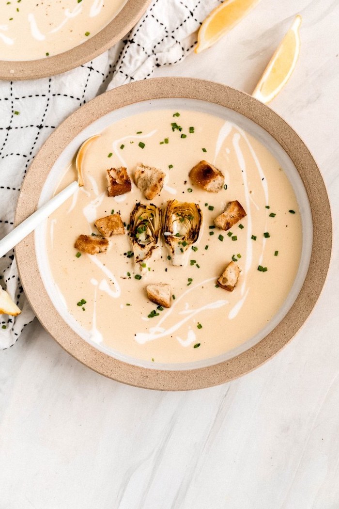 marble countertop, white table cloth, creamy potato soup recipe, ceramic bowl full of soup with croutons