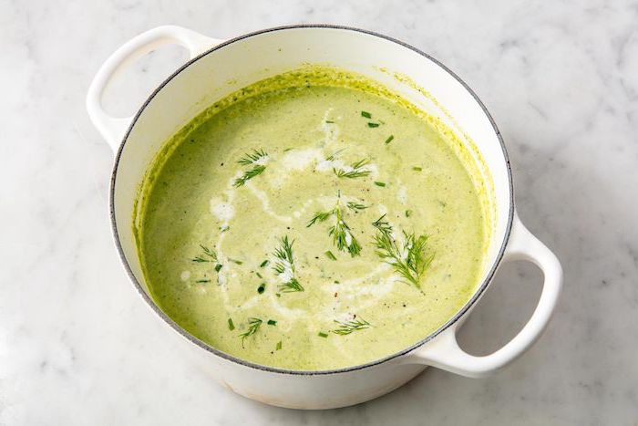 white pot full of soup, fresh dill on top for garnish, on marble countertop, creamy potato soup recipe