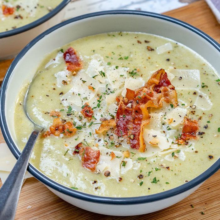 white bowl full of soup, bacon and chili powder on top for garnish, how to make soup, wooden table