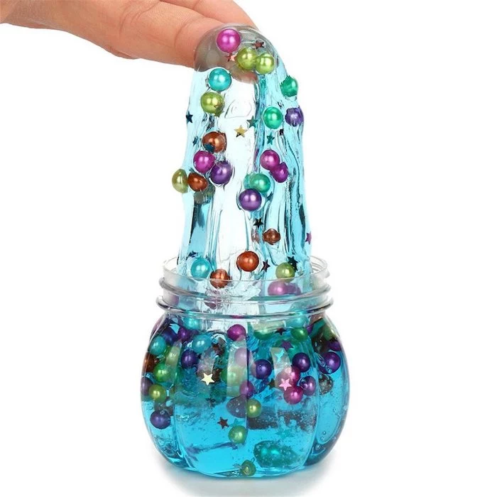 crunchy slime, blue with colorful pearls and stars inside, in a jar, how to make slime with glue, white background