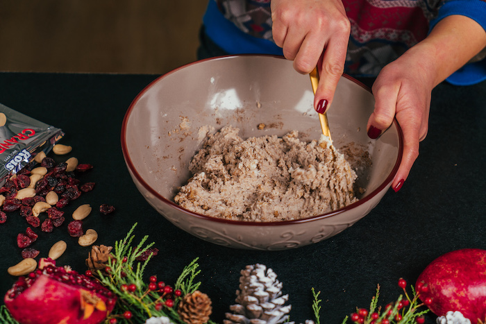 different ingredients mixed in ceramic bowl, cream cheese christmas appetizers, placed on black surface