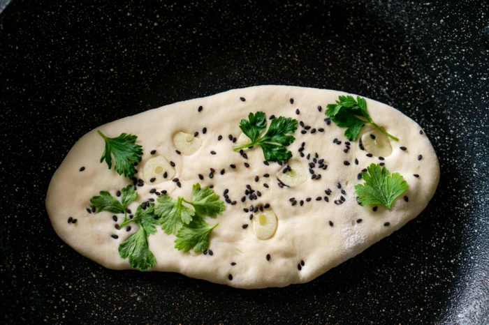 dough with parsley and garlic, black sesame seeds, baked in a pan, naan bread recipe
