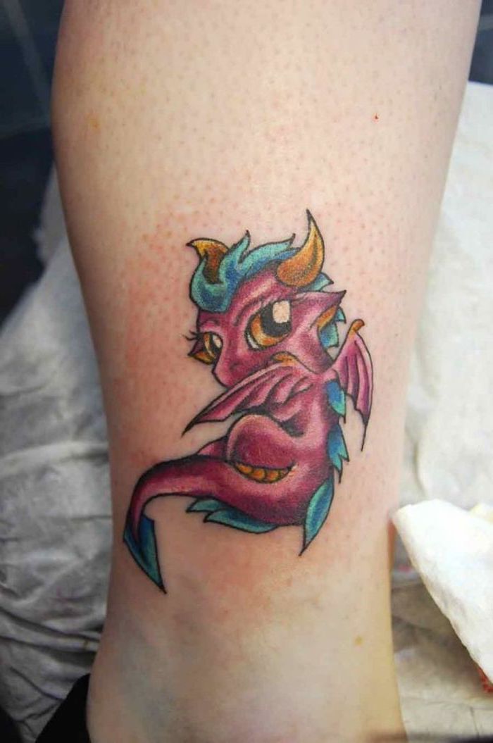 japanese tattoo meanings, small baby dragon, in pink blue and yellow, ankle tattoo, yellow horns