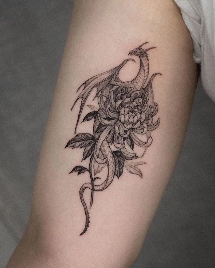 dragon holding flowers, inside arm tattoo, japanese tattoo meanings, grey background