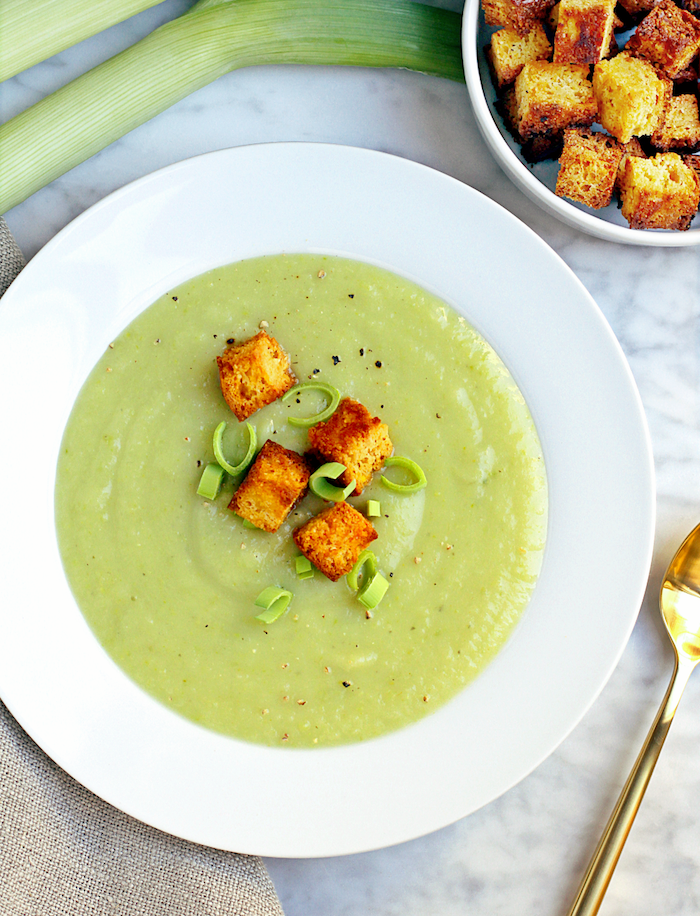 lemongrass soup with croutons, in a white plate, easy soup recipes, bowl full of croutons, marble countertop