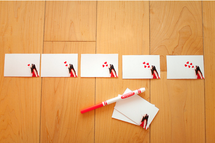 flip book pages, girl blowing kisses in the corner, placed on wooden surface, christmas gifts for men