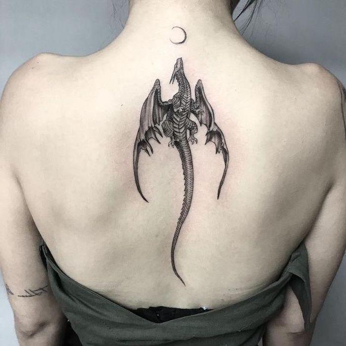 dragon tattoo meaning, dragon flying towards the moon, back tattoo, woman wearing green top