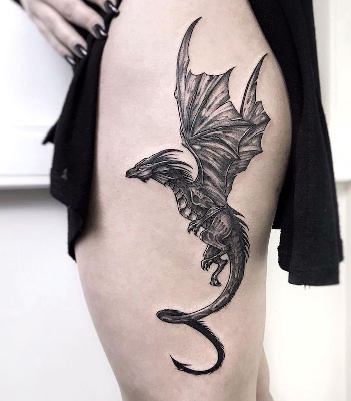 side thigh tattoo, viserion from game of thrones, dragon tattoo meaning, woman wearing black dress, white background