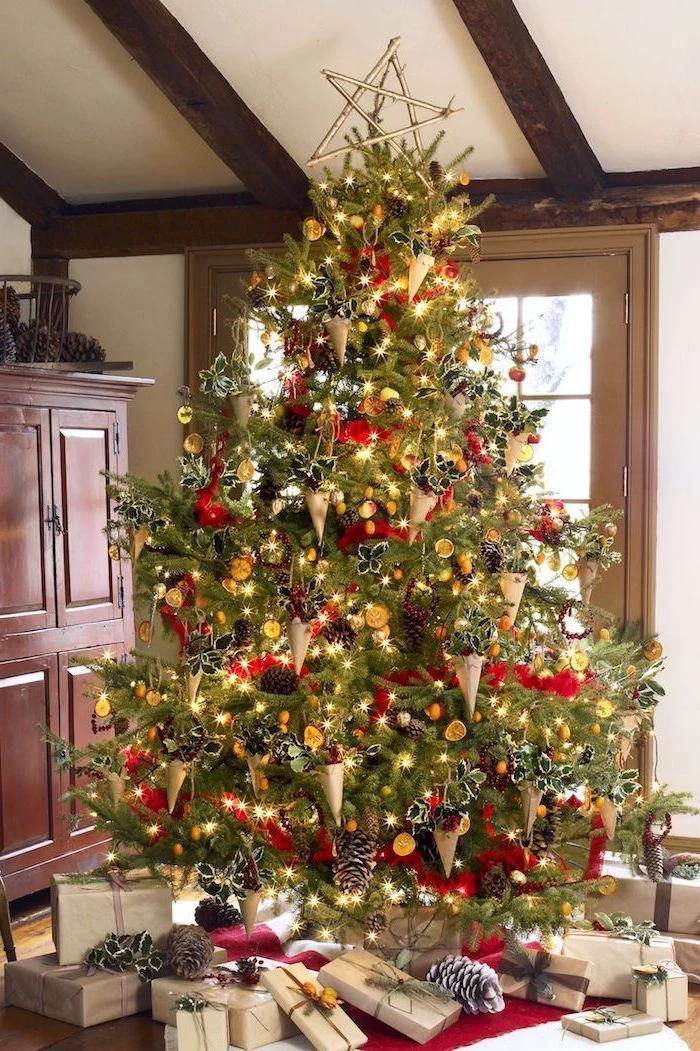 large tree decorated with red ribbon, paper cones with flowers inside, colorful christmas tree, presents underneath