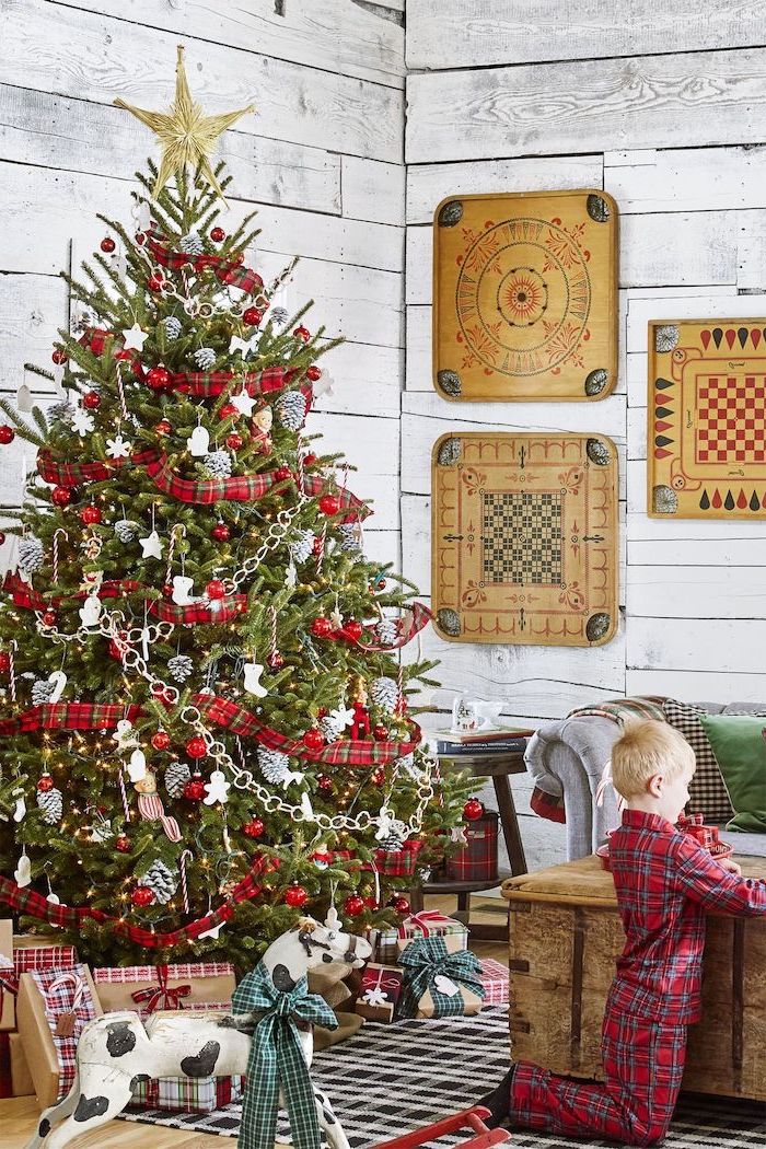 tree decorated with silver ornaments and stars, red flannel ribbon wrapped around it, rustic christmas tree, gold star topper