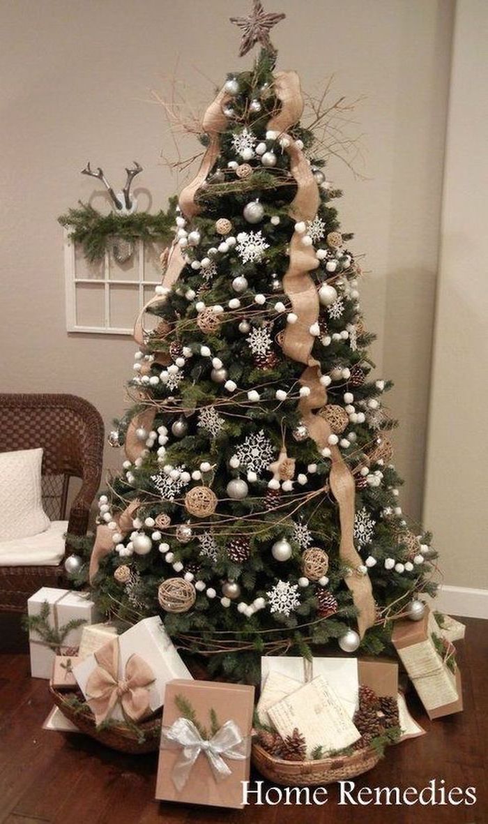 tree decorated with gold ribbon, gold ornaments and white snowflakes, rustic christmas tree, wrapped presents underneath