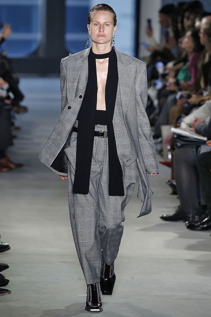 fall fashion trends, model walking down a runway, wearing all plaid suit, consisting of trousers and blazer 