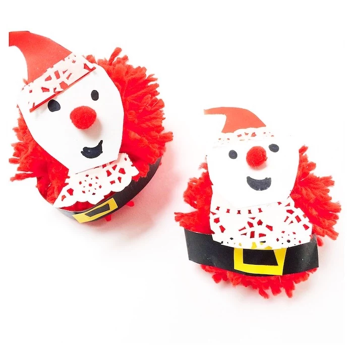 snowmen made of pompoms, red white and black carton, christmas craft ideas for kids, placed on white surface