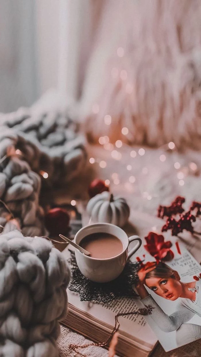 hot chocolate, placed on book on bed, cool desktop backgrounds, grey knitted blanket, fairy lights on the bed