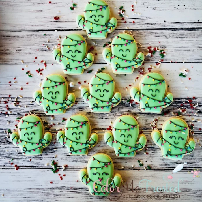 cactus shaped cookies, decorated with green icing, placed on wooden surface, royal icing for decorating cookies