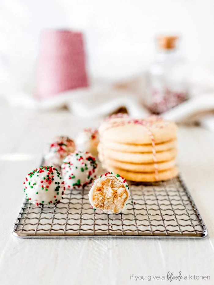truffles covered with white icing, red green and white sprinkles, arranged on metal rail, cookie icing recipe