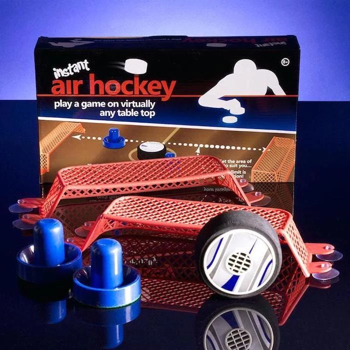 instant air hockey game, christmas gift ideas for boyfriend, pucks and goal posts, placed on black surface
