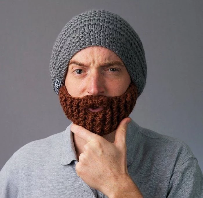 man wearing a grey knitted beard beanie, unique gifts for men, wearing grey t shirt, grey background