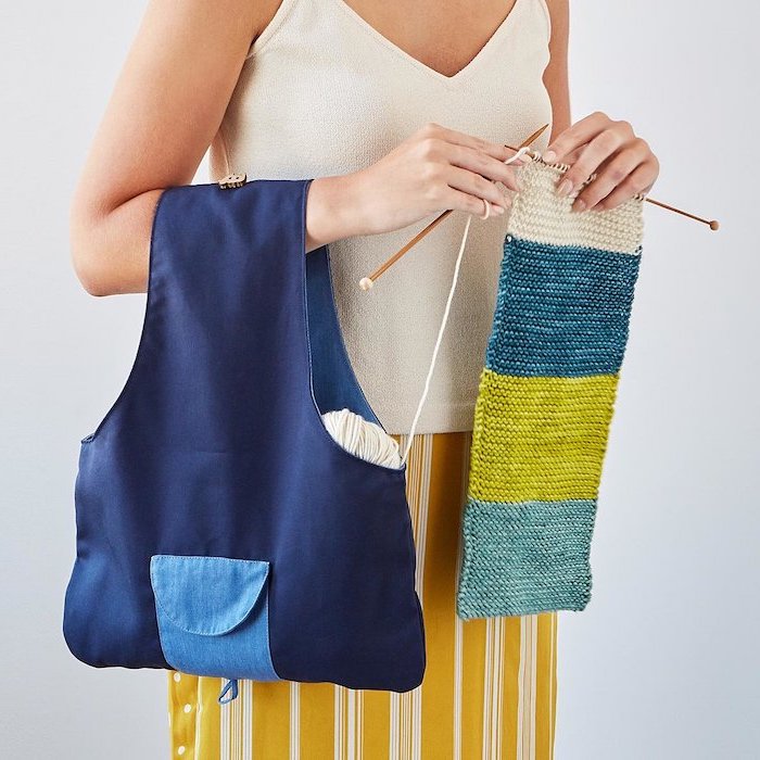 woman holding a knitting bag, wearing white top and yellow skirt, knitting a colorful scarf, christmas gifts for mothers