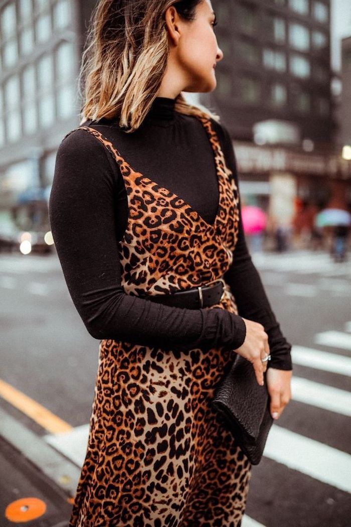 woman standing in the middle of the street, fall fashion trends, wearing black polo blouse, leopard print dress on top