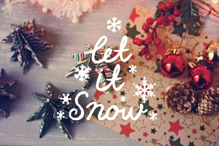 let it snow written over wooden surface, with origami christmas trees, winter desktop backgrounds, baubles pinecones and wrapping paper