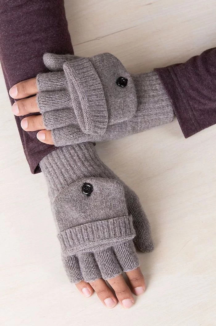 christmas presents for boyfriend, man wearing purple sweater and grey mittens, hands placed on wooden surface