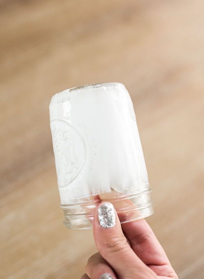 personalised gifts for mom, mason jar painted in white, held by female hand with silver glitter nail polish