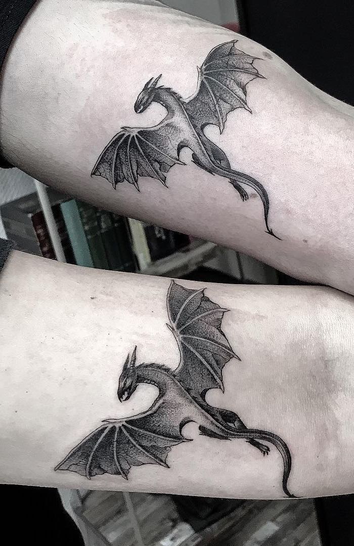 flying dragon silhouette tattoo