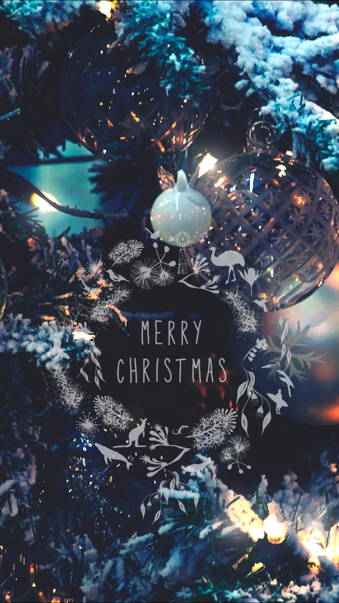 merry christmas written over background, of decorated christmas tree with lights and baubles, screen saver wallpaper
