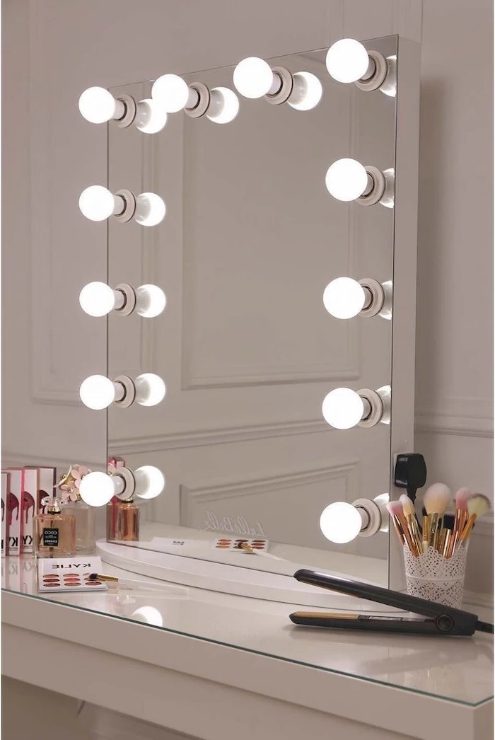 hollywood mirror with lights, placed on white vanity with make up on it, christmas gifts for mom from daughter, leaning on white wall