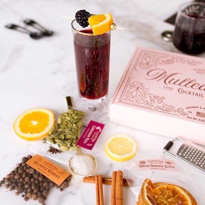 mulled wine cocktail set in a carton box, christmas gift ideas for mom, cinnamon sticks berries and dries orange slices