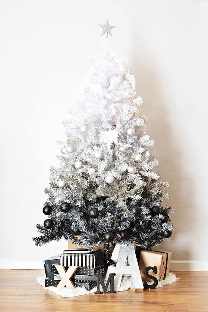 black and white ombre faux tree, wrapped presents underneath, decorating christmas tree with ribbon, decorated with black and white ornaments