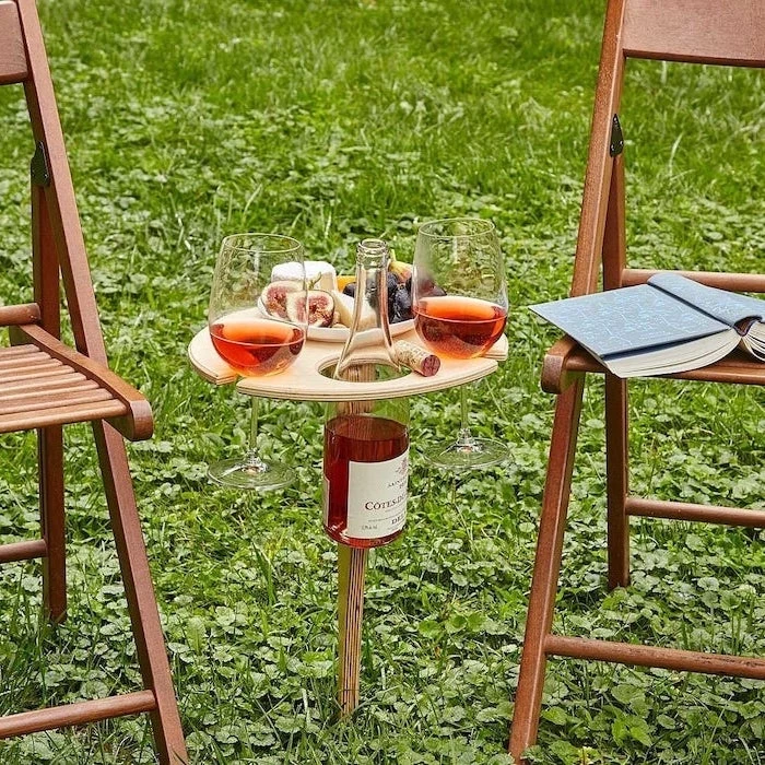 wooden wine table for outdoors, diy gifts for mom, two wooden chairs on each side, wine bottle glasses and cheese on it