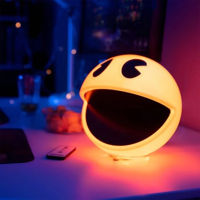 pac man shaped lights, placed on bed side table, good gifts for boyfriend, blurred background