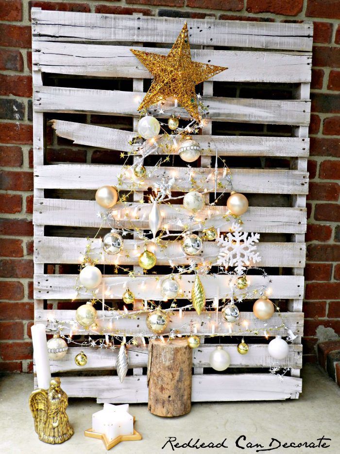 pallet christmas tree, made with lights and silver and gold ornaments, christmas tree ribbon, large gold star on top