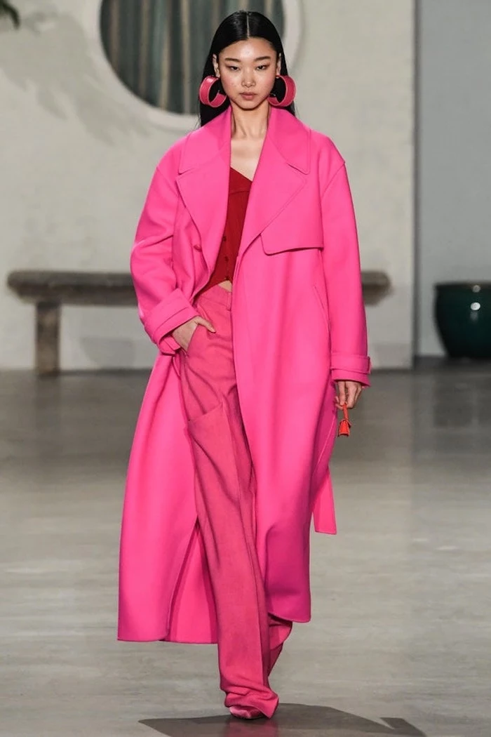 model with black hair walking down the runway, wearing all pink outfit, 2019 fashion trends, large hoop pink earrings
