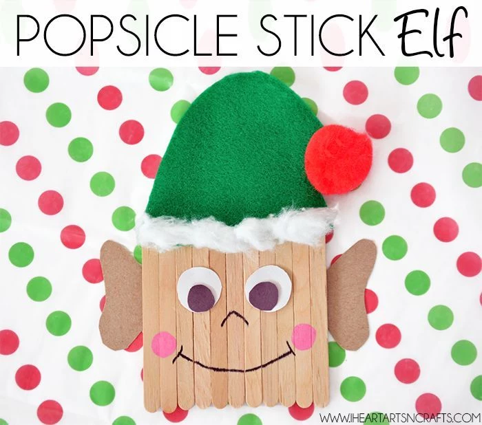 popsicle stick elf, step by step diy tutorial, christmas crafts for kids, green hat made of felt, placed on white sheet with red and green dots