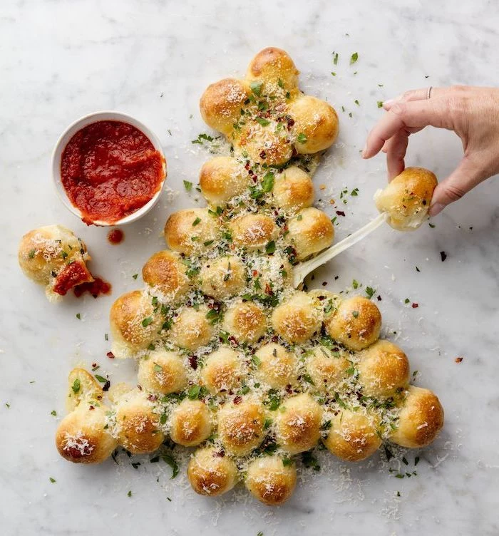 pull apart christmas tree, bread with garlic butter and herb, easy holiday appetizers, tomato sauce in a small bowl on the side