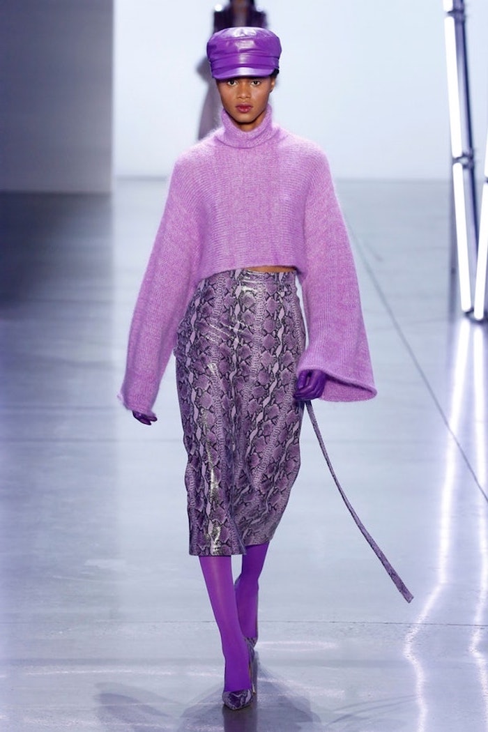 woman dressed in all purple, 2019 clothing trends, leather hat and gloves, purple snake skin print leather skirt and sweater