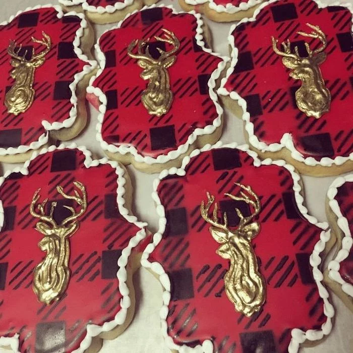 red and black checkered icing, gold deer decoration on top of cookies, royal icing for decorating cookies, placed on white surface
