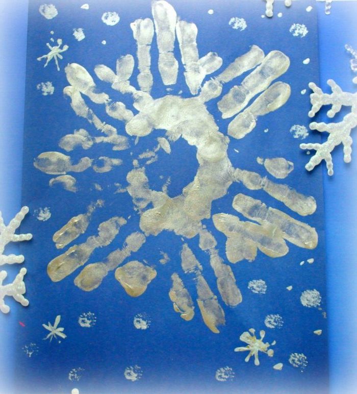 silver snowflake made with handprints, painted on blue carton, diy ornaments for kids, christmas card