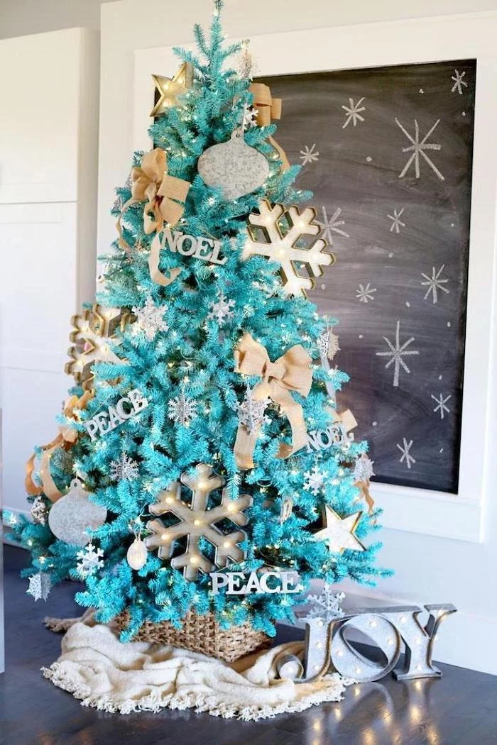 turquoise faux tree, decorated with silver ornaments, gold bows and large snowflakes with lights, tree decorating ideas