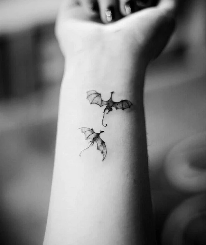 two flying dragons, wrist tattoo, dragon forearm tattoo, black and white photo