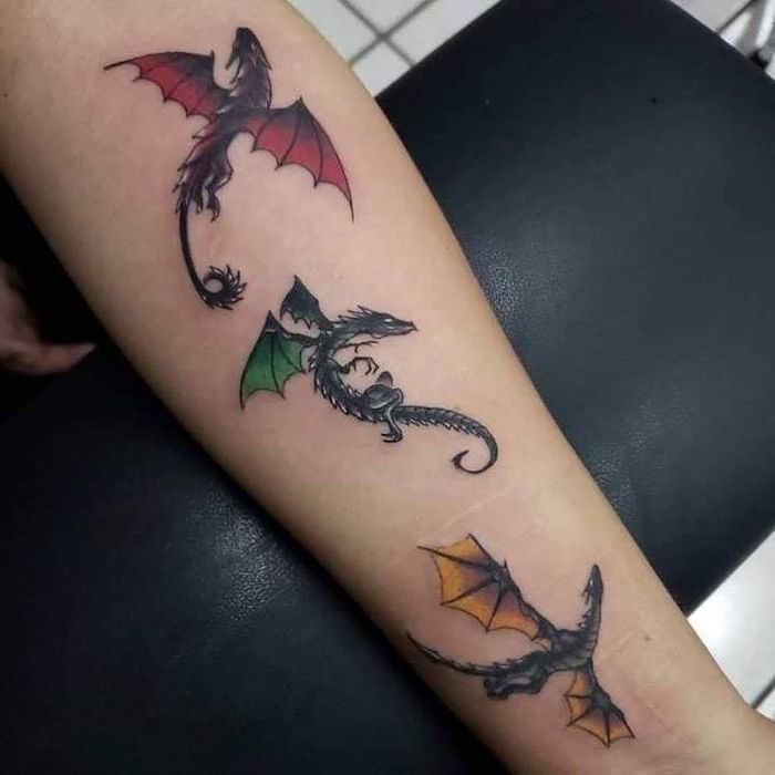 drogon viserion and rheagal from game of thrones, forearm tattoo, dragon forearm tattoo, black leather stool