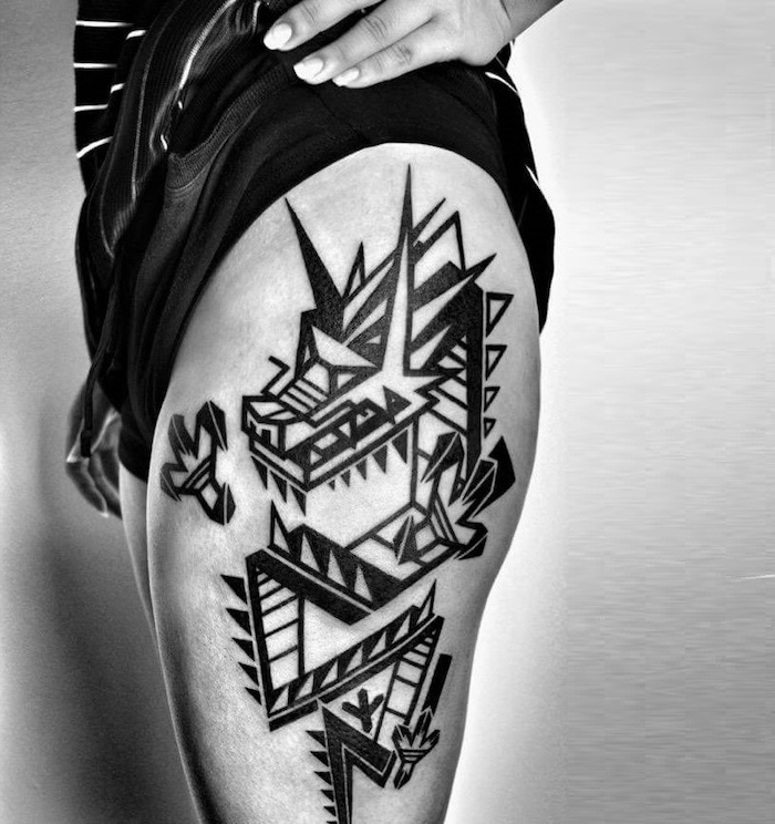 geometrical dragon, side thigh tattoo, dragon tattoo design, black and white photo, woman wearing black shorts