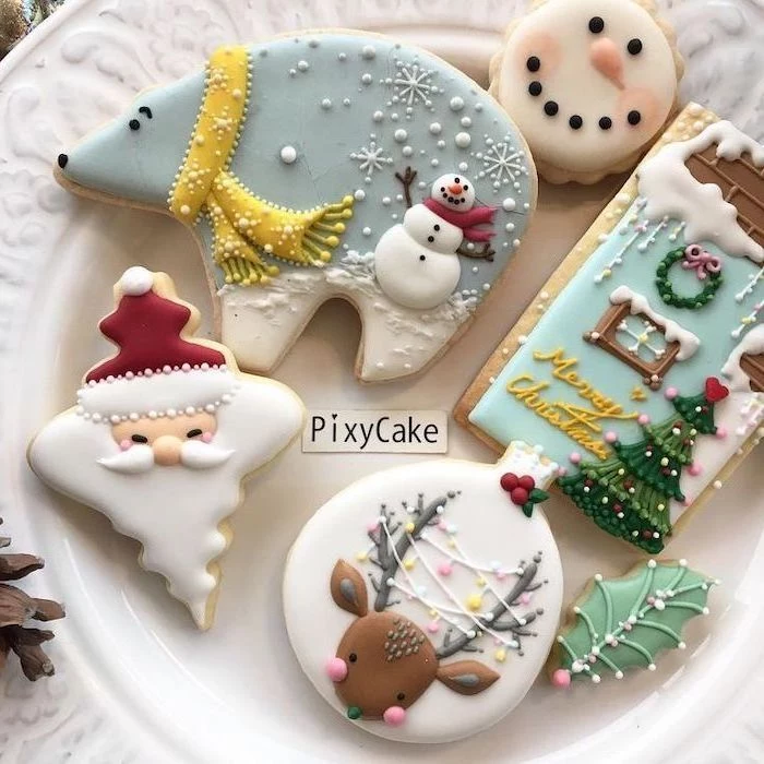 cookies in different shapes, placed on white plate, royal icing recipe for sugar cookies, bear and santa shaped cookies