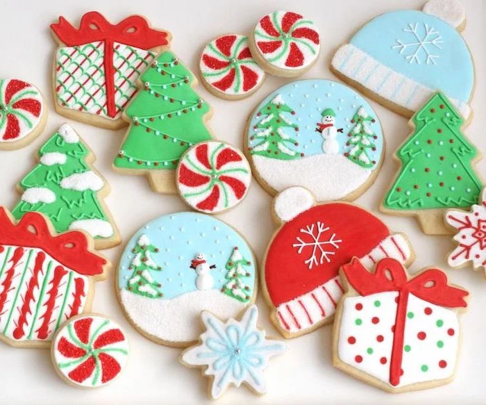 how to make royal icing for cookies, cookies in different shapes, decorated with colorful icing, placed on white surface